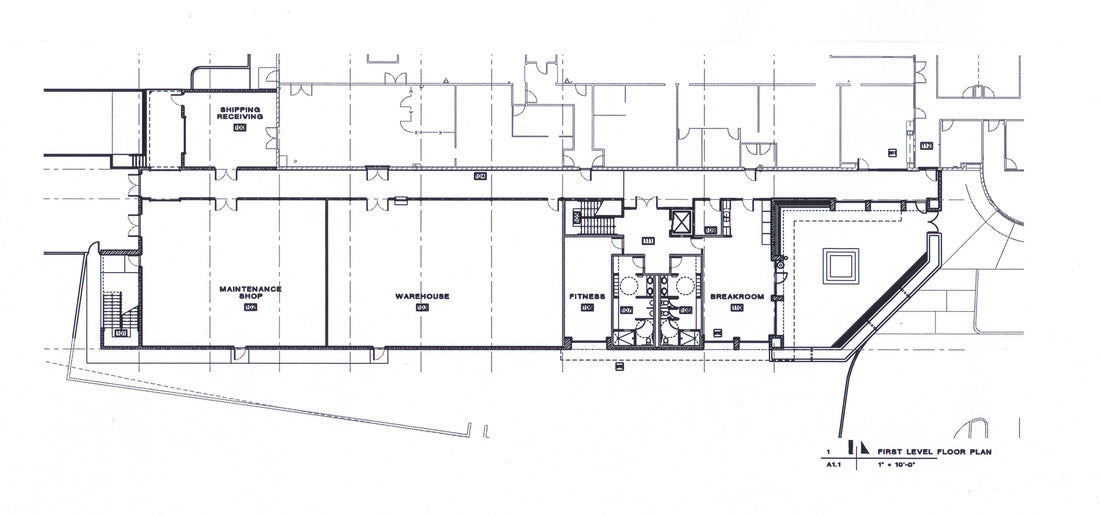 First-floor plan illustrating the organization of warehouse, maintenance shop, shipping and receiving, office support spaces, employee amenities, and circulation.