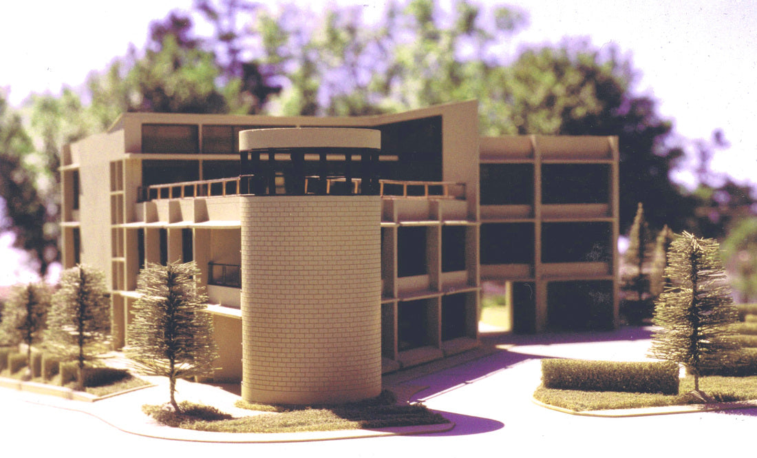 Architectural scale model of the proposed Chew Company headquarters in Victoria, British Columbia, showcasing the three-story office building, cylindrical corner tower, landscaped entry, and contemporary commercial design.