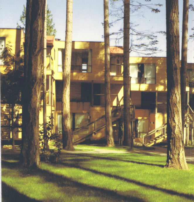 Completed Inn of the Sea Resort in Ladysmith, British Columbia, with low-rise waterfront condominium buildings nestled among mature pine trees and landscaped grounds.