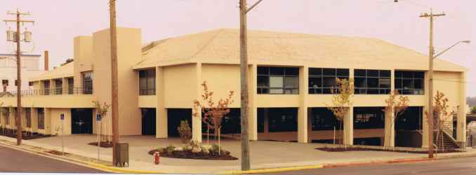 Completed Government Office Center in Nanaimo, British Columbia, featuring a three-story government office building with covered parking, contemporary architecture, and streetscape landscaping.